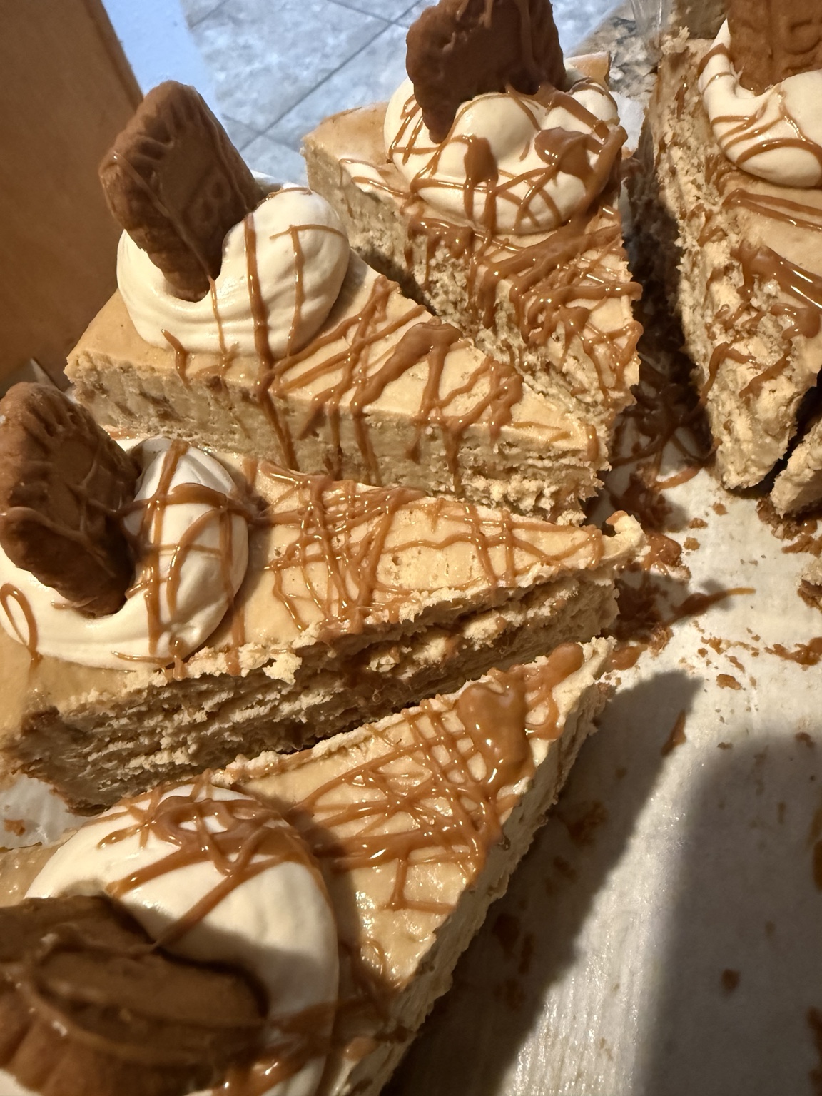 Biscoff cheesecake slices topped with cookies and sauce